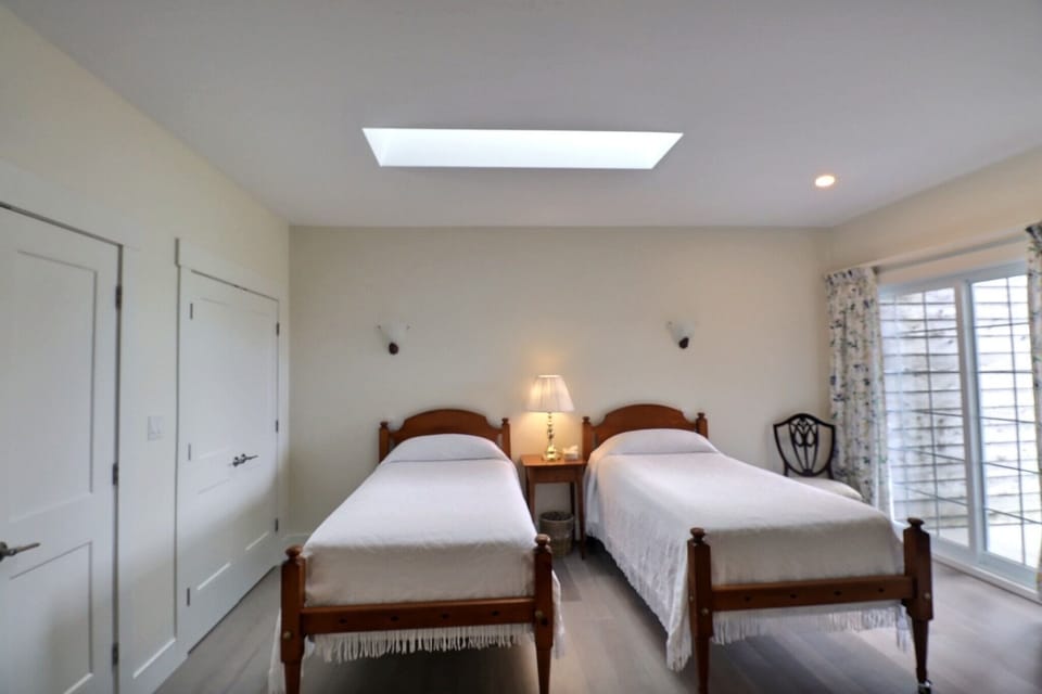 Guest bedroom with private balcony and two large closets