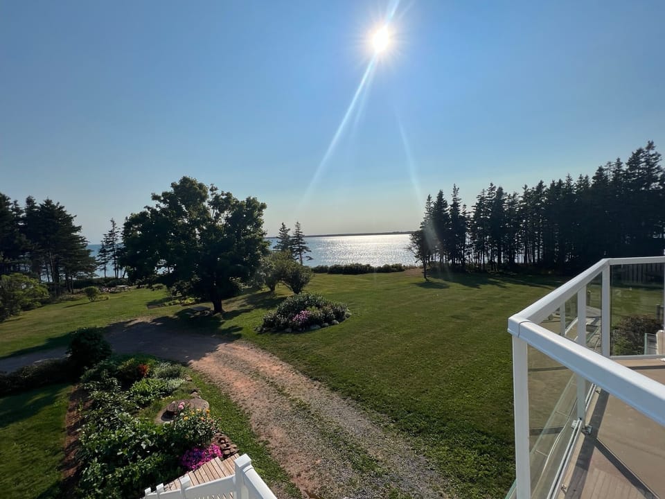 View  from Spry 6, Spry 7, Spry 4, and Spry 3 overlooking the Northumberland Strait and out towards Boughton Island. In May and June dozens of lobster boats are fishing these waters. Kitchen herb garden in located just below.