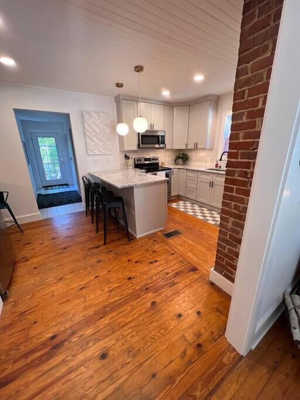 Kitchen, electric stove, coffee maker, toaster, microwave, dishwasher. 