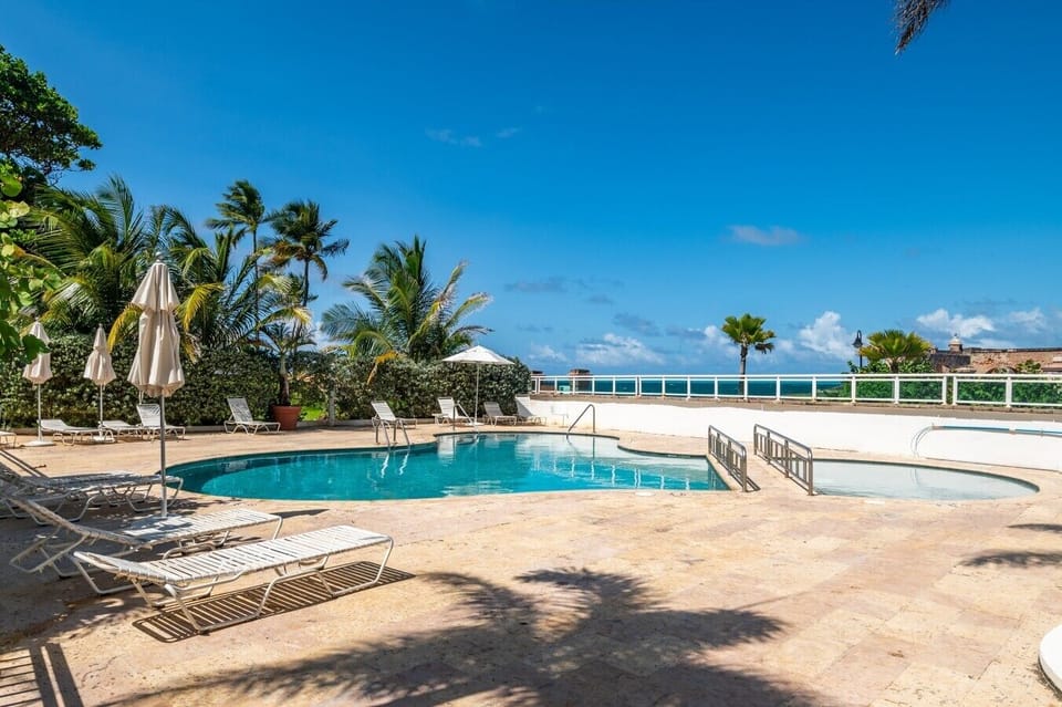 Relax in the sunny outdoor whirlpool surrounded by tropical plants.