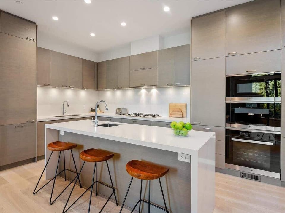 - Sleek kitchen with modern cabinetry and built-in stainless appliances  
- Spacious island with bar seating for cooking and conversation  
- Well-equipped layout ideal for gourmet meals and family dining  