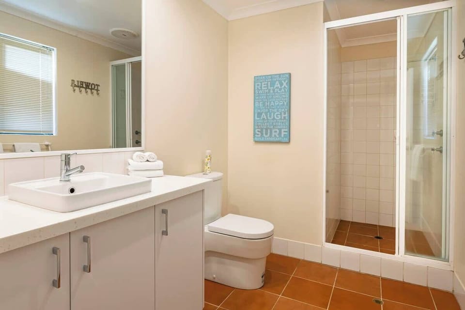 The first bedroom enjoys privacy and convenience with an ensuite bathroom with enclosed shower.