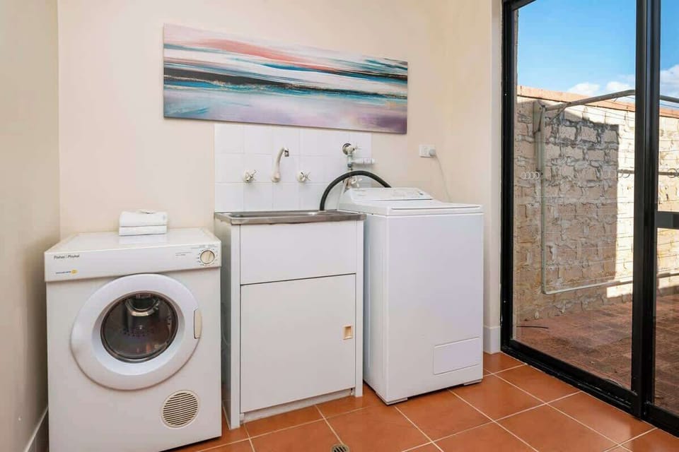 The home offers laundry facilities with a washer, dryer and outdoor clothes hanging space to keep everything fresh.