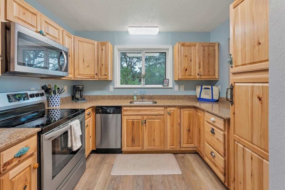 Kitchen opens up to the dining area and has large windows to let the natural light in.