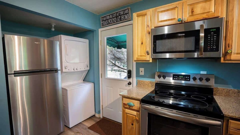 Stacked washer and dryer in the kitchen for convenience of longer stays.