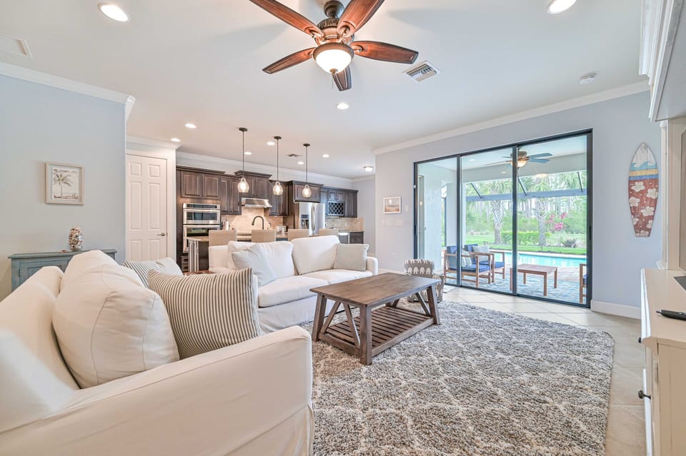 Villa Paradise at The Preserve - Living with 65" smart TV and sliding doors opening up to the screened in pool area