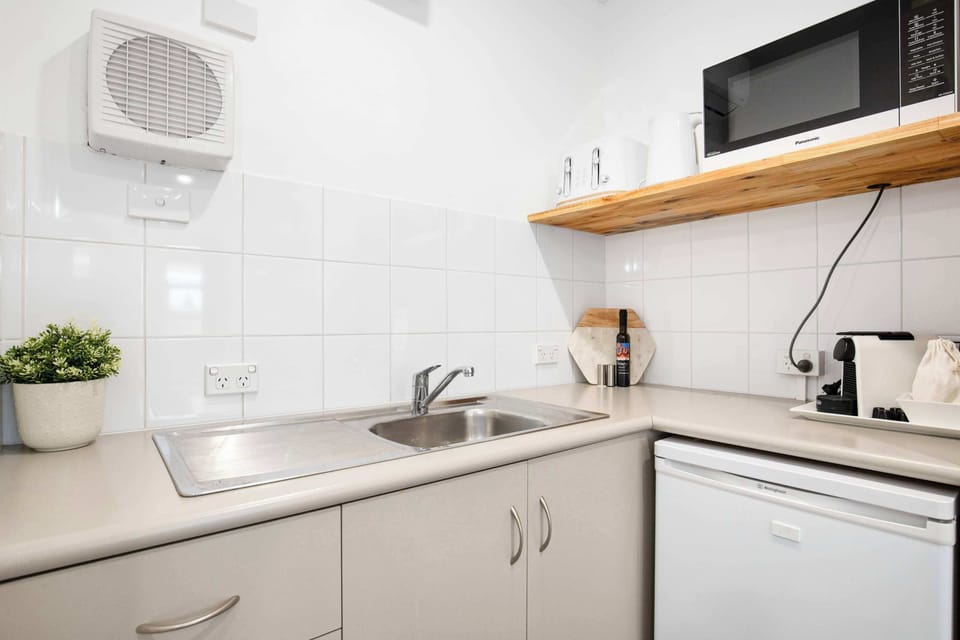 Kitchenette, featuring mini fridge/freezer, kettle, coffee pod machine,toaster, mircrowave and hot plate