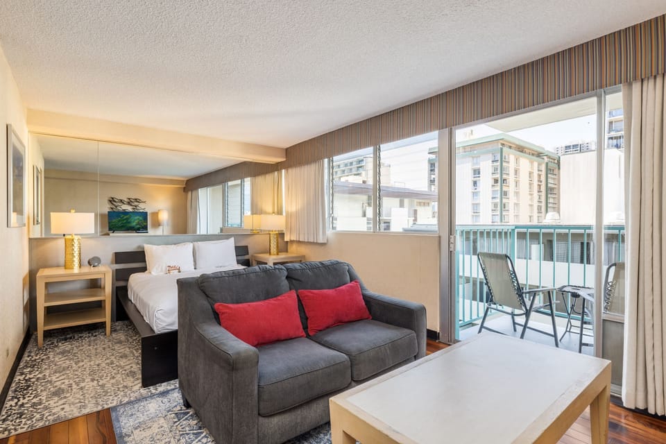 Unwind in your bright, modern suite with plush bedding, a cozy sofa, and your own private balcony overlooking the city. You'll love the tasteful design and all the comforts that make this space truly yours.