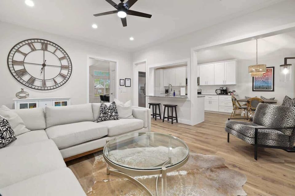 Here, you'll find a plush sectional, a 65-inch Sony Smart TV, working electric fireplace and large windows with lots of natural light.