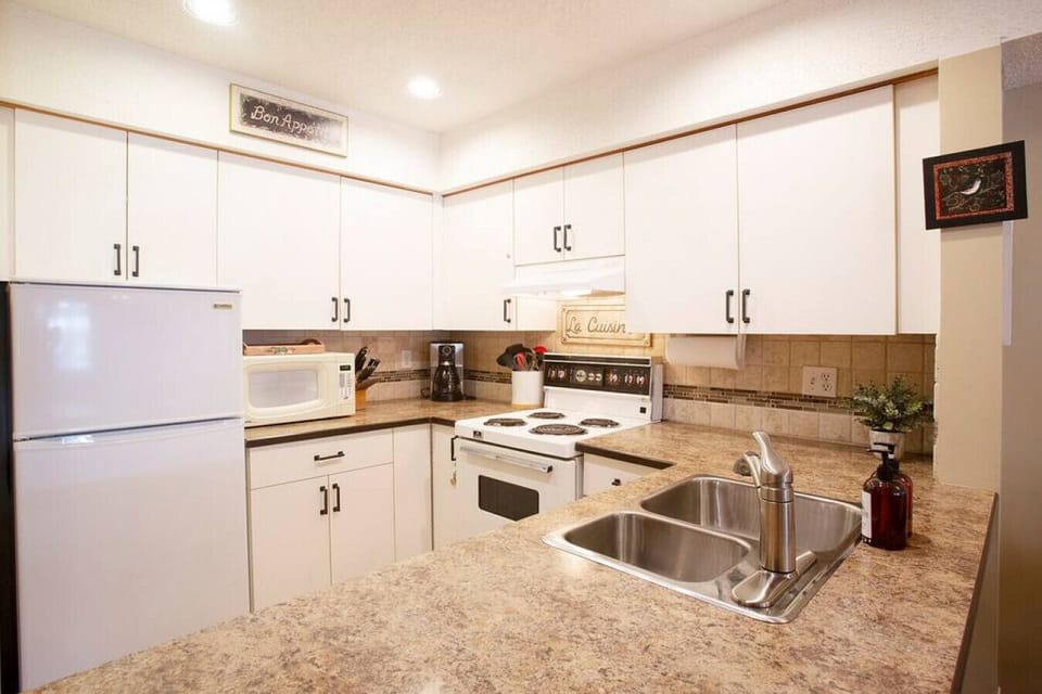 Large Fridge, Lots of appliances including: Toaster, microwave, oven, stove, kettle, coffee maker  more.