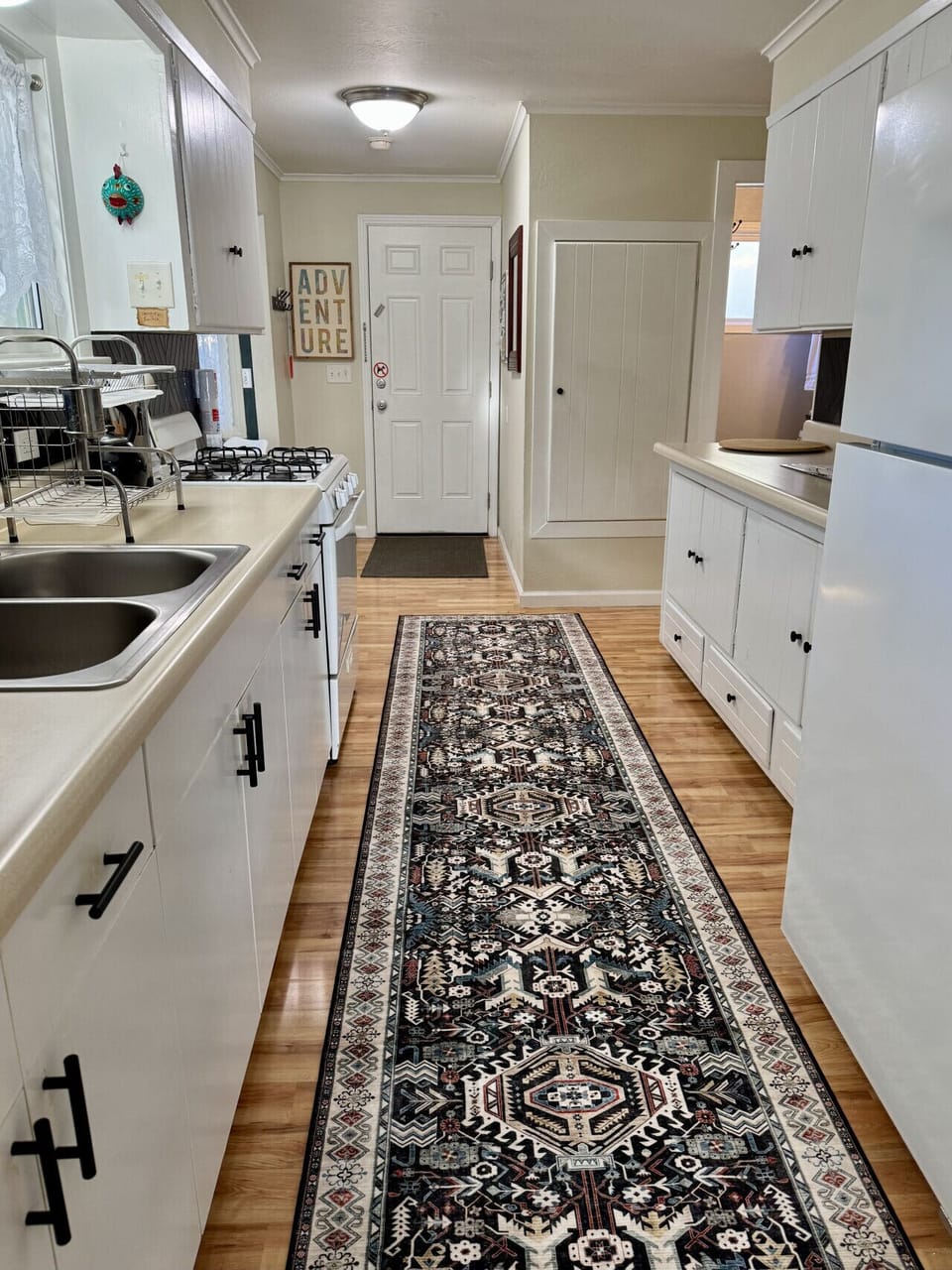Fully stocked kitchen with coffee maker, toaster, microwave, cookware, and cutlery
