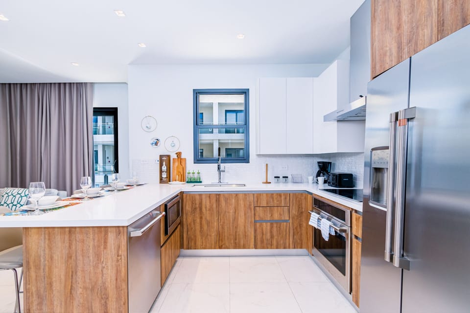 Opulent Kitchen of the 2BR condo in Noord Aruba - Well-lit space with strategically placed task lighting - Elegant and coordinated color palette for a cohesive look - Fully Equipped