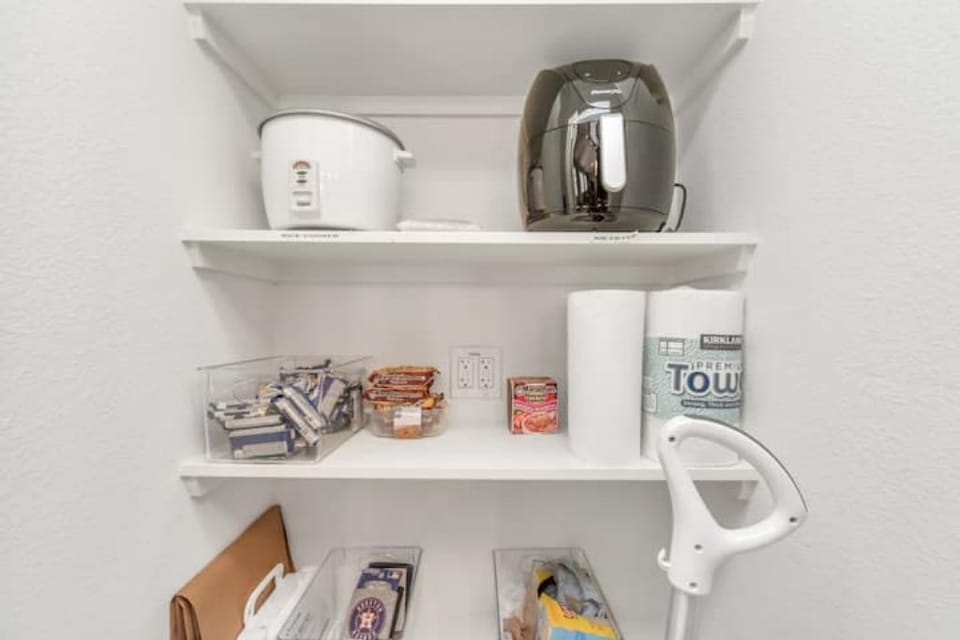 Pantry with rice cooker, air fryer, and other essentials to make cooking easy.