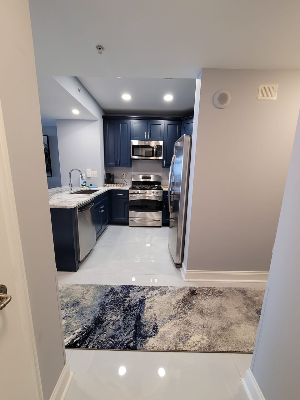 New Midnight Blue Cabinets with Marble Counter Tops