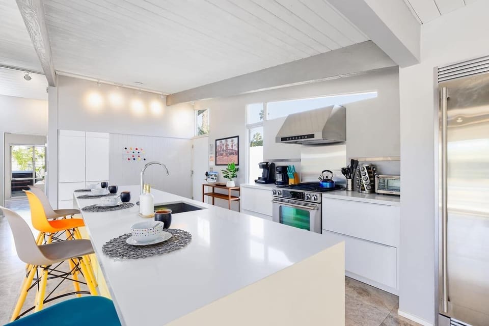 Well-proportioned kitchen with cooking basics and appliances plus bar seating for four. 