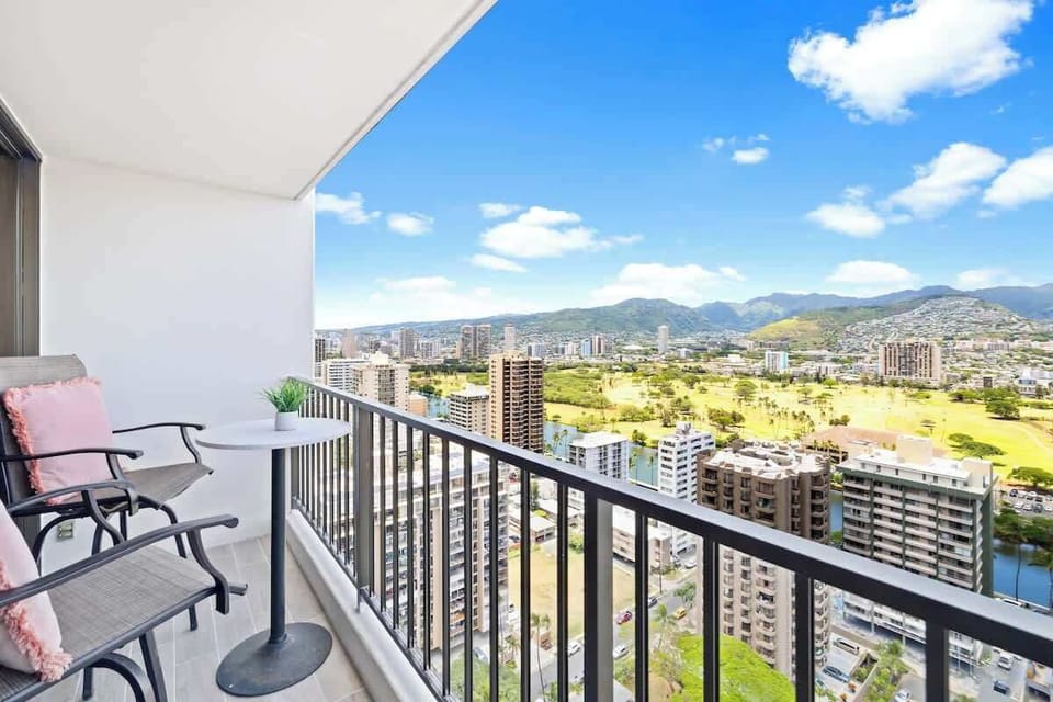 Savor the sunshine and sweeping panoramic views of the city and majestic mountains from this inviting private balcony.