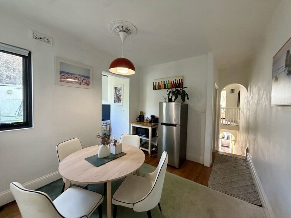 Light-filled dining nook beside a compact kitchen