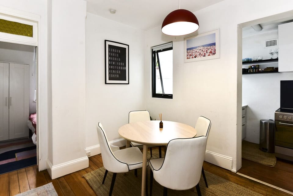Open dining area with mid-century lighting and flow to bedrooms