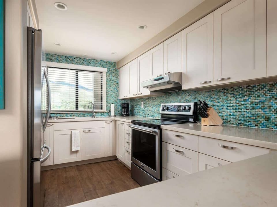 Modern kitchen, great memories! Enjoy cooking with stainless steel appliances against a beautiful backsplash.