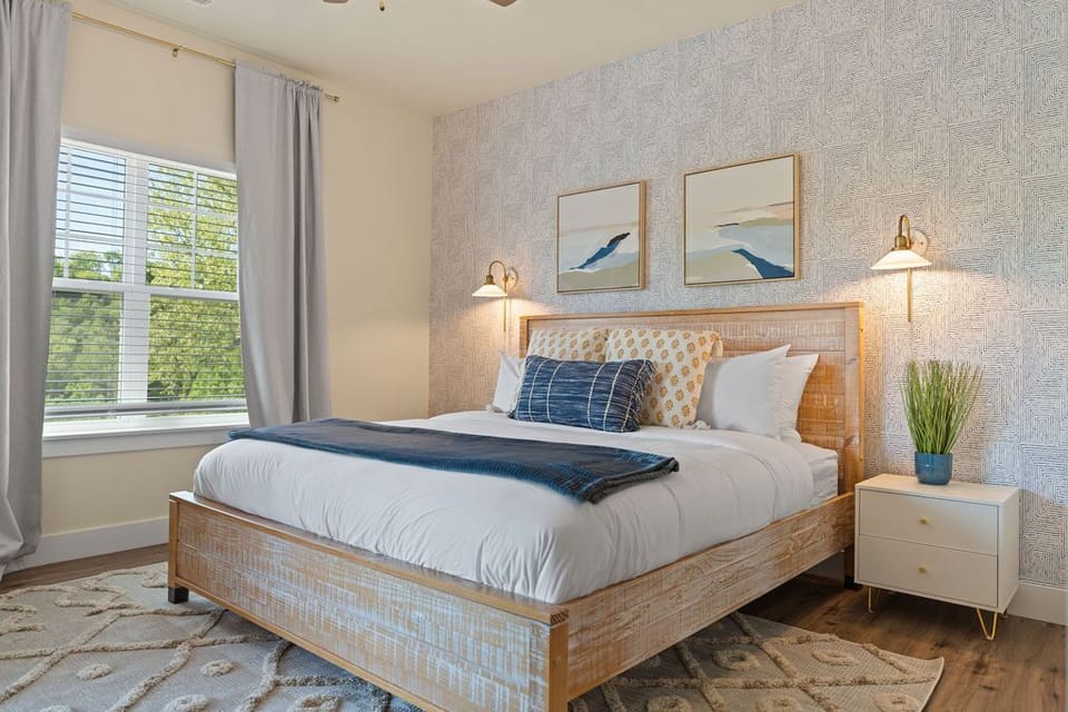 Master Bedroom with King bed, incredible lake views, entrance to deck and ensuite bathroom