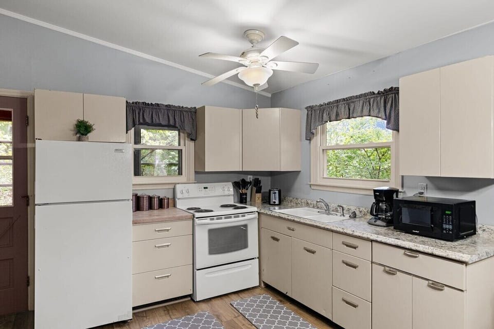 Well-appointed kitchen with refrigerator, range, microwave and all the tools you need to prepare tasty meals