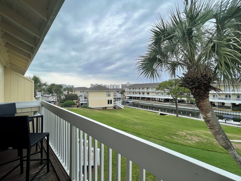 Step out to your private balcony and soak in peaceful waterfront views framed by swaying palms and manicured lawns.