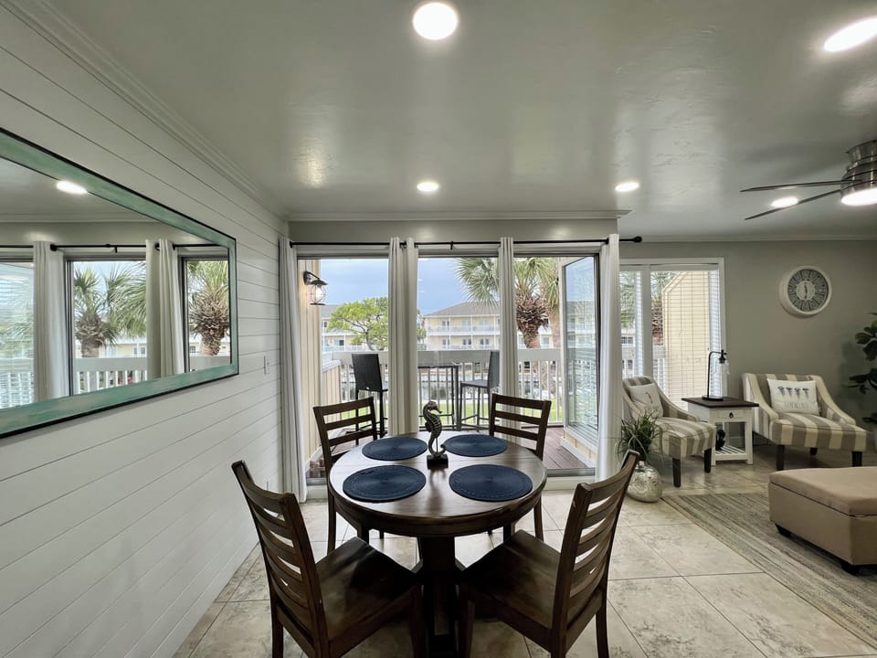 Relax in your bright, open-concept space where dining and living areas flow together seamlessly. Large windows frame palm trees and balcony views for coastal charm.