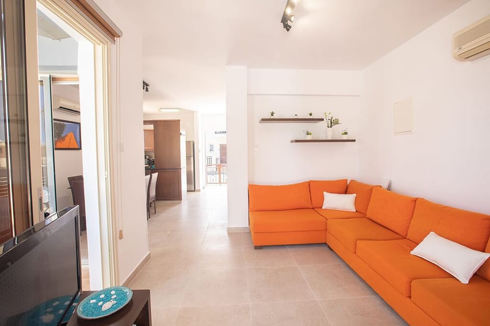 Living room with comfortable corner sofa and widescreen TV