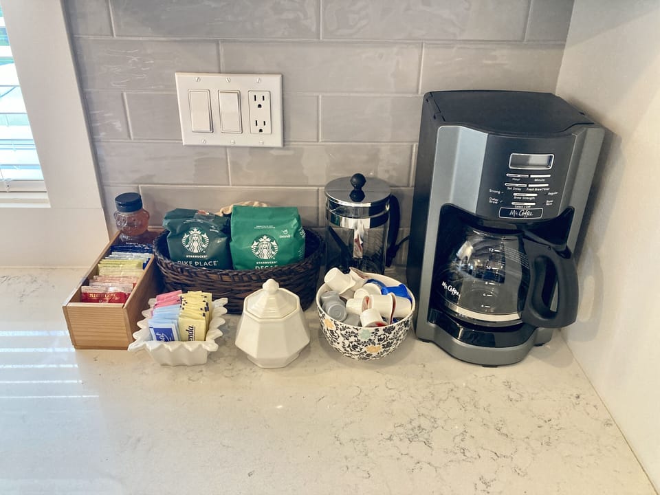 Fresh coffee, creamer, sugars, tea & more ready for morning (even if you’re not)