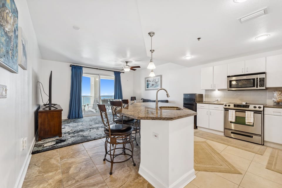 Open-concept kitchen and living area with ocean views and modern appliances