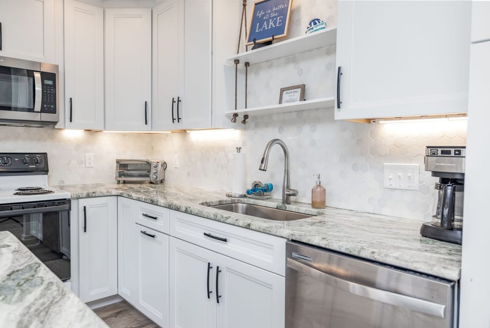 Fully stocked kitchen with ample counter space and updated appliances.
