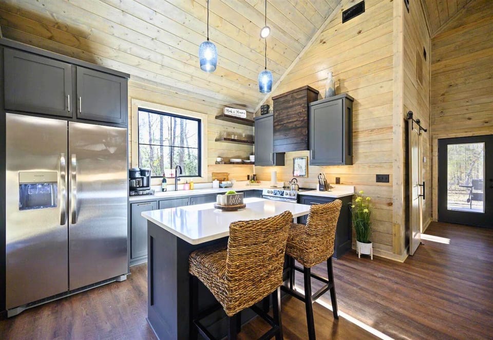 Step into our kitchen where modern meets the mountains. Start your day with a serene view and a hot cup of joe right here!