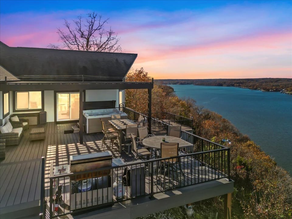 The vast deck provides a bird's eye view of the lake valley below highlighted by several seating options and hot tub.