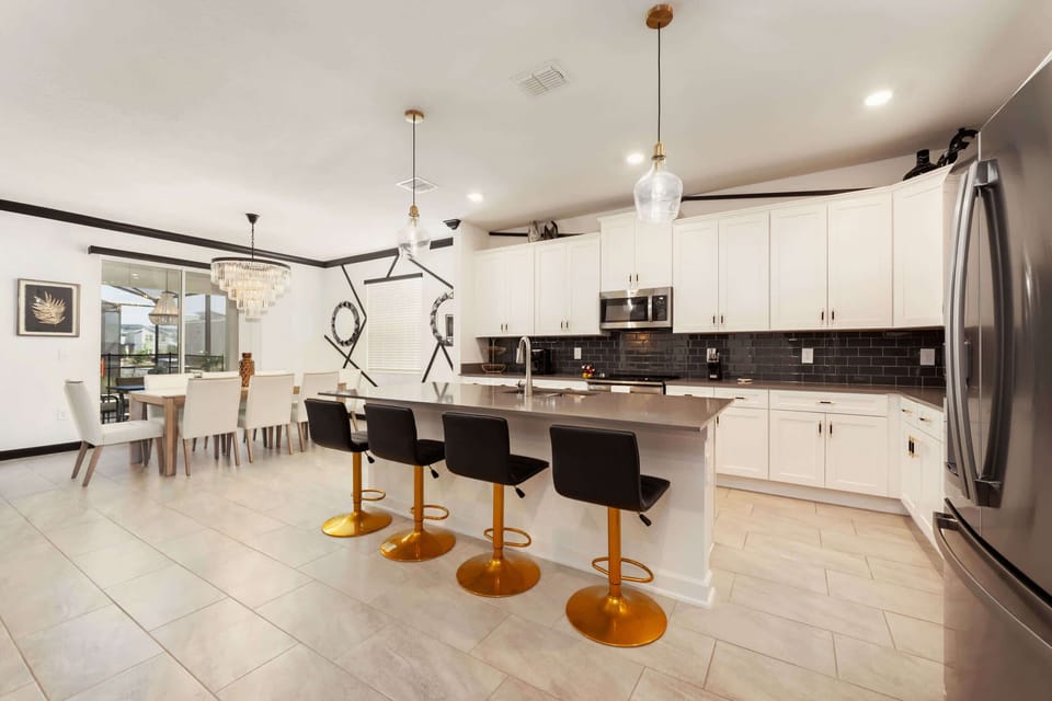 Elegant kitchen and dining area with modern amenities and stylish decor, perfect for entertaining large groups.