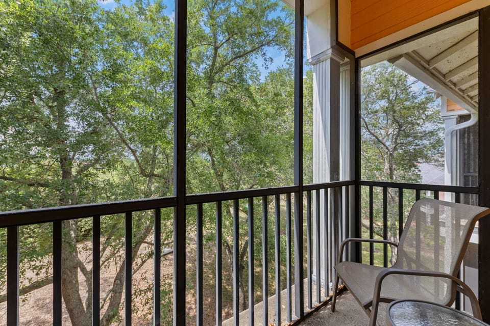 Lounge, relax, and recharge in this airy screened balcony oasis