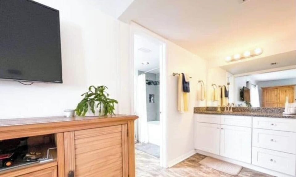 Dressing area in the North master bedroom features a walk-in closet. The tub and shower can be seen to the left.