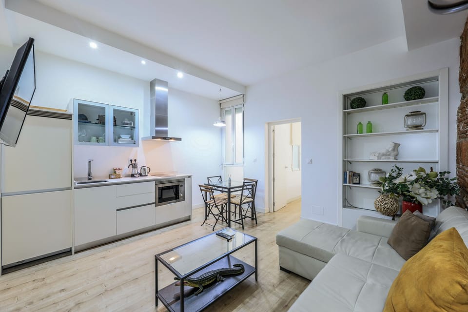 View of the living room space, dining room space and kitchen