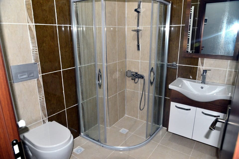 Shower, rainfall showerhead, hair dryer, towels