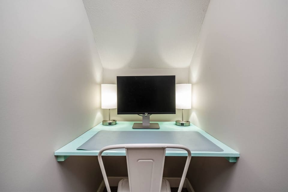 Basement workspace offers a dedicated desk, and soft lighting–perfect for remote work, studying, or catching up on emails during your stay.