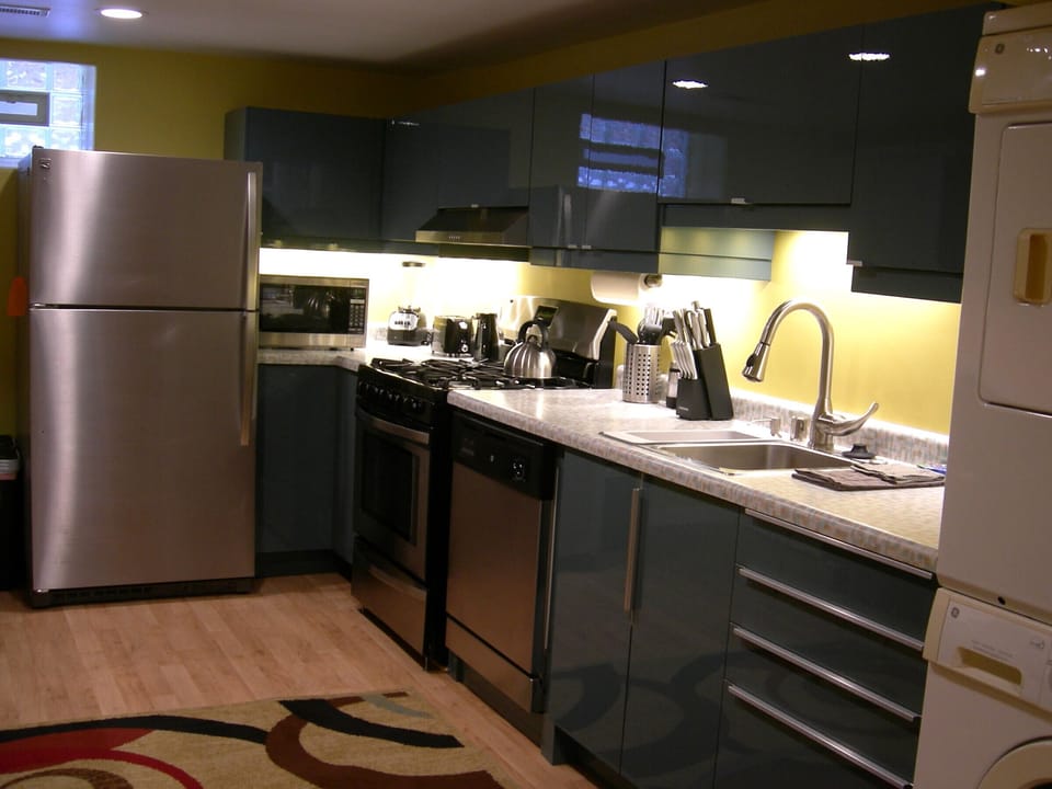 Stainless Steel refrigerator with ice maker, microwave, gas range & dishwaasher.