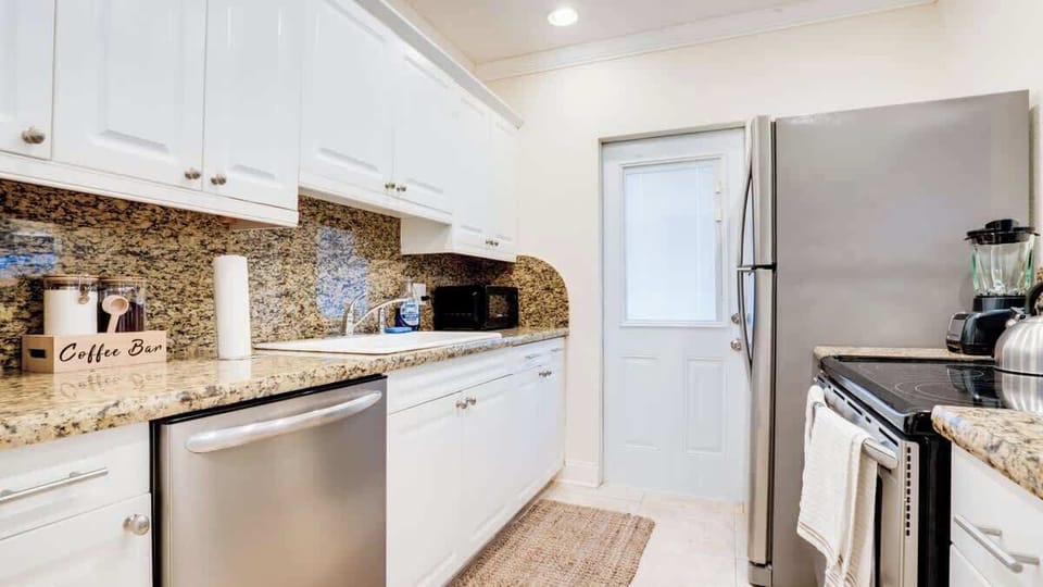 Fully stocked kitchen with complete set of cookware.
