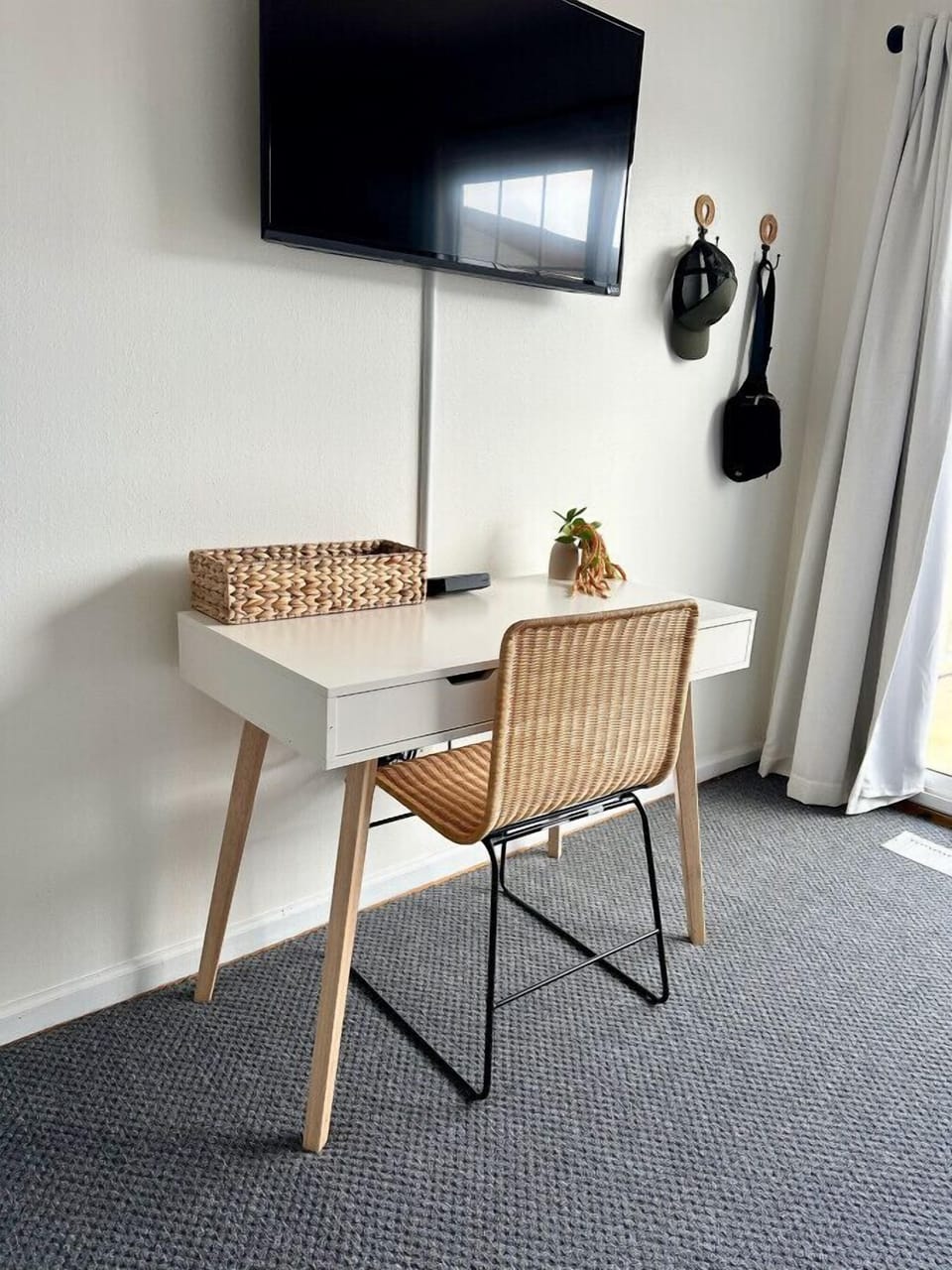 Desk and table located in spare bedroom for remote work.