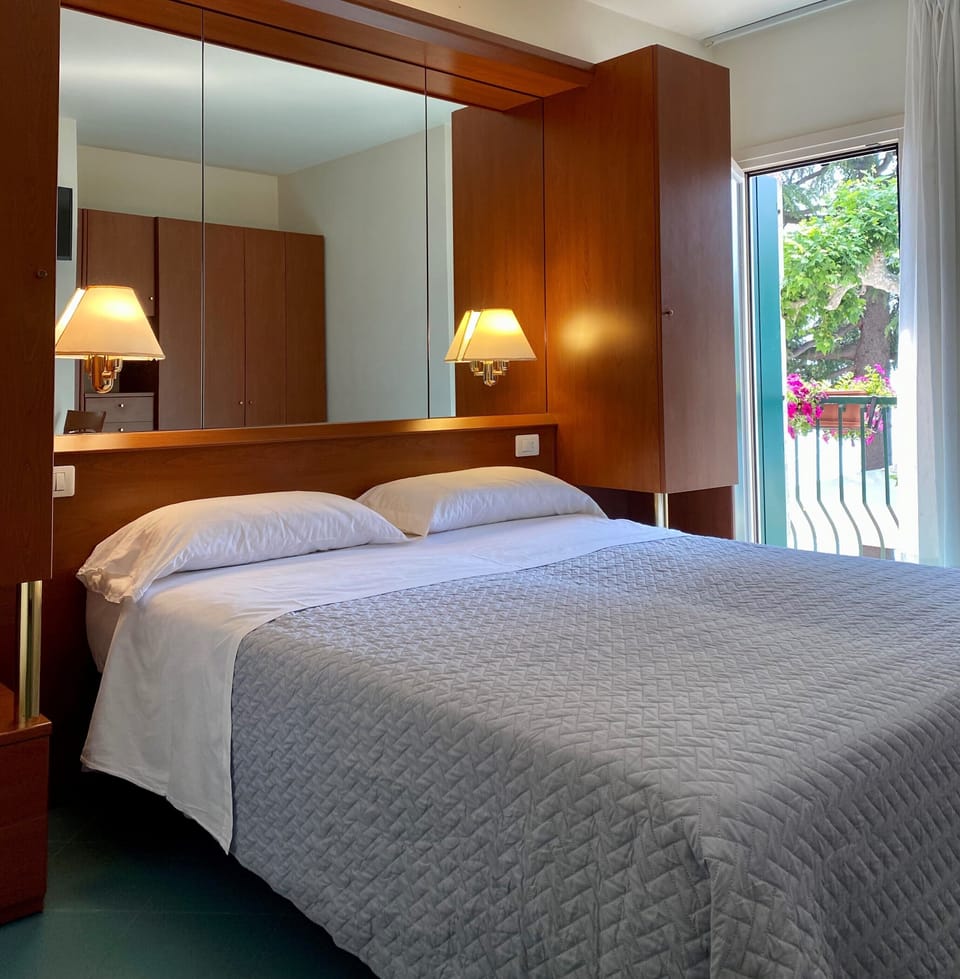 Standard Double Room | Minibar, in-room safe, blackout drapes, iron/ironing board