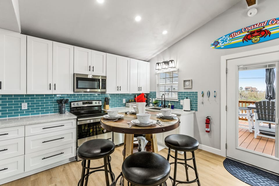 Kitchen: Bright and breezy with sleek appliances and charming dining setup!