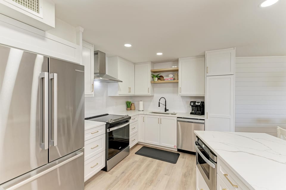 Modern white cabinets and marble countertops
