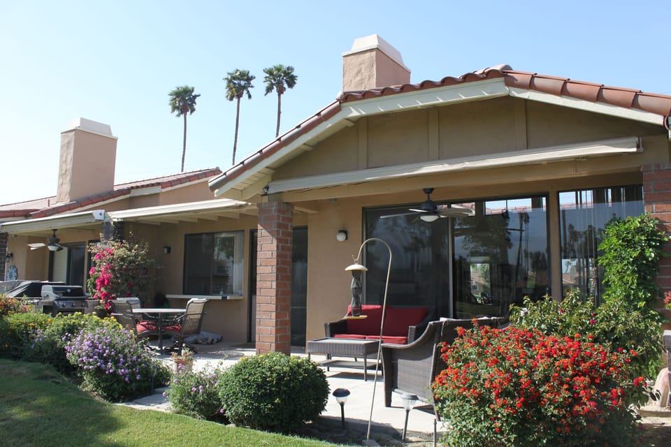 Back porch with seating area, electric awnings, outdoor ceiling fan, Weber bbq