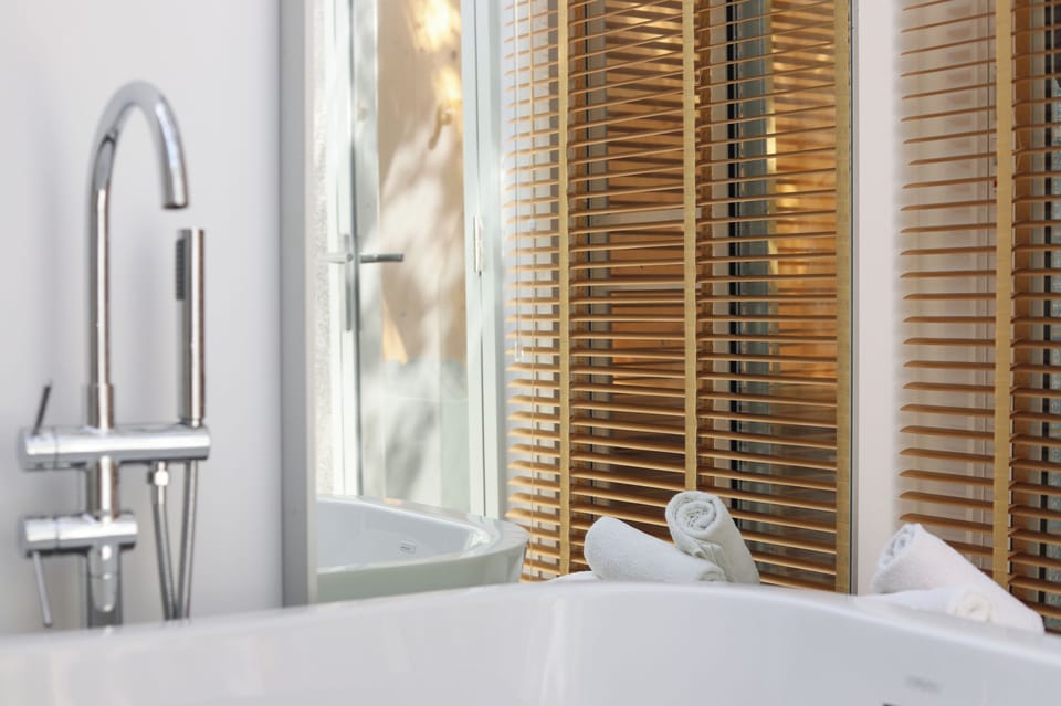 Sundance Beachfront Pool Villa | Bathroom | Separate tub and shower, rainfall showerhead, hair dryer, bathrobes