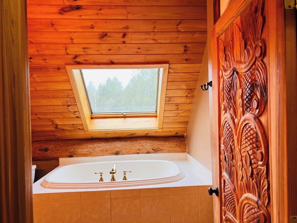 Upstairs Full Bathroom with a large tub and Shower