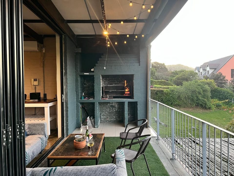 Your balcony area with stacking doors opens up the lounge into the braai area completely. You are welcome to move the couches as desired to enjoy the space. Drop down blinds to keep bad weather out. 