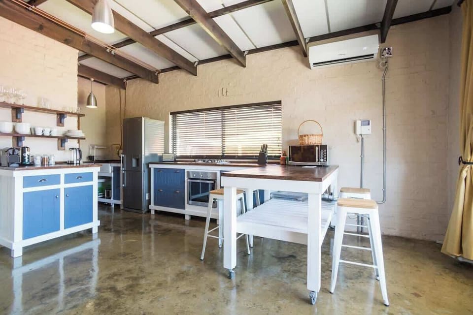 A fully equipped kitchen with full fridge, electric oven, 4 plate gas stove, microwave, kettle, toaster and Nespresso machine. Moveable dining station and seating.